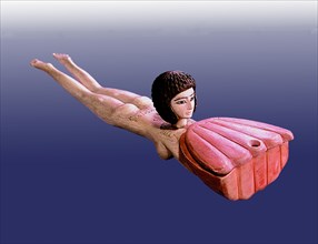 A cosmetic box for storing ointment in the form of a naked female swimmer, probably representing the sky goddess Nut, carrying a pink lotus flower
