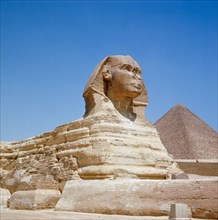 The Giza Sphinx with the pyramid of Khufu in the background