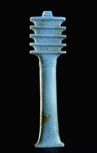 Blue glass furniture inlay depicting a djed (stability) pillar which by the New Kingdom was regarded as a symbol of Osiris