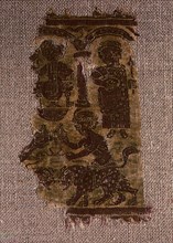 Tapestry fragment depicting a seated dignitary and a standing woman watching two youngsters leading panthers