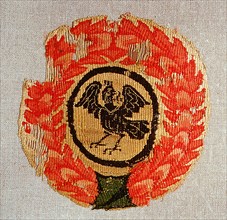 Textile medallion depicting bird in glory