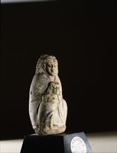 Cosmetics bottle in the form of a seated figure