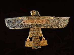 Inlaid gold pectoral in the form of a falcon with outstretched wings, from the tomb of Amenemope