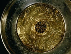 Silver bowl with gold handle and inset repousse gold centre, decorated with an aquatic scene showing four young girls swimming amongst lotus flowers and fish