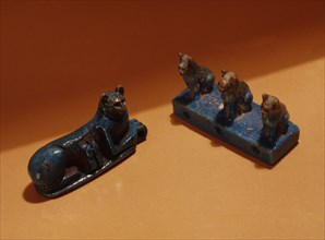 Amuletic spacer bead in the form of three sitting cats and an amulet in the form of a reclining cat with two suckling kittens