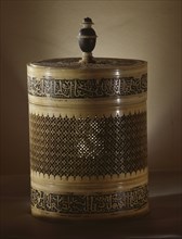 Cylindrical ivory box with carved and openwork decoration inlaid with black, pitch like substance
