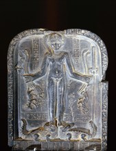 Stele with relief sculpture of Horus with the side lock of hair of youth, standing on two crocodiles