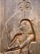 The goddess Seshat, personification of Writing, shown in the act of inscribing the palm leaf rib which denotes the word renpet, year in the hieroglyphic script