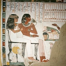 A detail of a wall painting in the tomb of Pere depicting the tomb owner and his wife before an altar laden with offerings