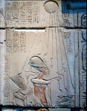 Sunk relief from the facade of a shrine showing Akhenaten and Nefertiti offering libations to Aten, the sun god