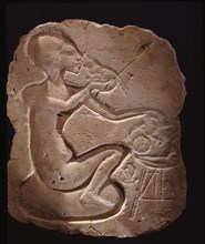 Relief fragment depicting a princess sitting on a cushion and eating
