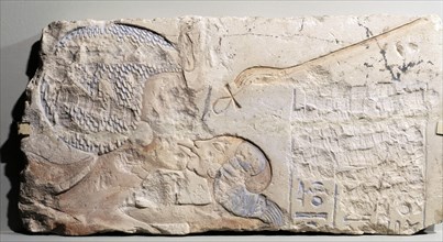 A fragment of a relief showing Nefertiti kissing her daughter, perhaps Merytaten, under the rays of the Aten