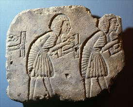 Fragment of a sunk relief showing scribes rendering accounts