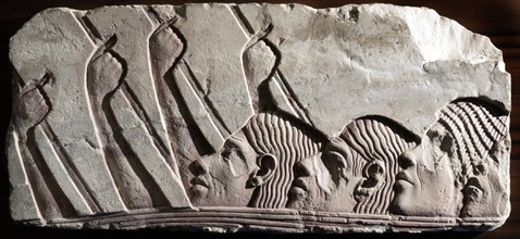 A fragment of a relief, depicting heads of foreigners during a procession