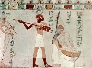 A detail of a wall painting in the tomb of Zeserkaresonb depicting a man and women playing string instruments