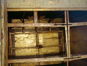Rear wall of the innermost gilt shrine of Tutankhamun with the earliest known depiction of the sky as a cow supported by eight gods of Unending