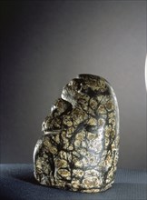 Mottled stone figure of a crouching ape