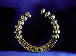 An unusual type of torque which seems to be modelled on necklaces made of large pearls decorated with mouldings