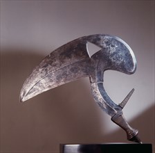 Throwing knife with blade shaped like a birds head, probably a hornbill