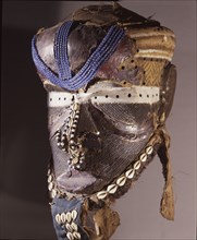 A helmet mask known as Mboom or Bwoom representing local pygmies, the common people, in a play retelling the myth of Bushoong royal origins, performed at major funerals, royal ceremonies and initiatio...