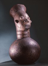 Jar depicting the womens headdress and the lengthened skull achieved by binding the heads of babies among the Mangbetu