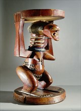 Stool supported by a female figure, served as an emblem of status and prestige for Songye chiefs
