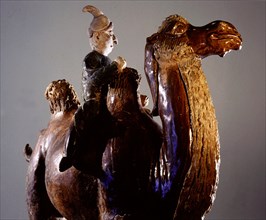 Sancai glazed tomb figure of a camel and foreign rider with an exaggeratedly large nose
