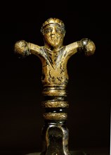 Bronze sword handle in the shape of a human figure