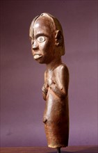 Mumba bwiti figure, positioned on top of a reliquary containing the bones of ancestors and magical preparations, both to protect them and as a focus for sacrifice
