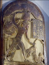 Tutankhamun smites a lion with a curved khepesh sword