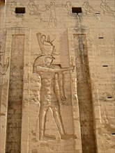 Outer wall of the Pylon relief depicting Horus the Elder wearing the crowns of upper and lower Egypt