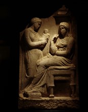 Greek funerary stela showing two women, one seated, the other, possibly a slave, holding a baby