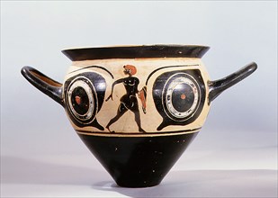 Attic black figure mastoid cup, the painted scene depicting a large pair of eyes, between them a naked youth holding a red cloak