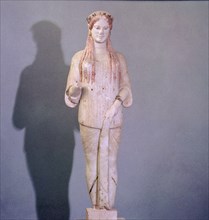 A figure of Kore with archaic smile and Ionic costume and hairstyle