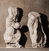 Part of the Erechtheum frieze showing three male figures
