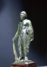 Bronze figure of Heracles, holding the Nemean lion skin over his left arm and a club in his right hand
