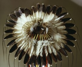 The eagle feather war bonnet, symbol of the outstanding warrior and a source of spiritual power and inspiration, utilized an ingenious method of rawhide strap attachments that made the feathers moveme...
