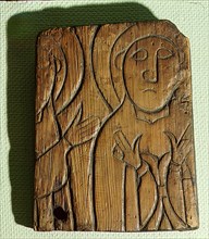 One of the Flatatunga softwood panels incised with a design depicting saints