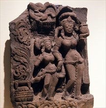 A woman and a girl bearing offerings