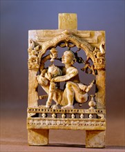 An ivory panel probably from a bed or a swing carved with an erotic scene