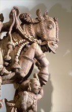Wood carving of warrior prince on horseback, part of a processional chariot