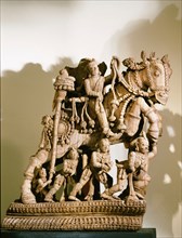 Wood carving of warrior prince on horseback, part of a processional chariot