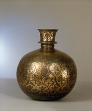 A huqqa base engraved with a design of leaves and flowers