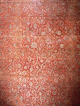 Red silk carpet with heavy silver arabesque designs