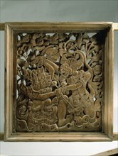 Wooden window panel from a temple, depicting Hanuman fighting a demon, a scene from the ancient Hindu epic, the Ramayana