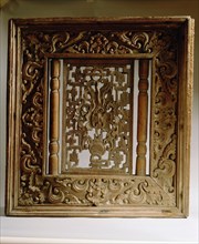 Wooden window panel from a temple, depicting a vase surrounded by cloud scrolls and the rising sun