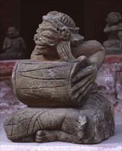 Sculpture of a kendang drum player, part of the famous stone gambuh orchestra that once adorned the royal palace of Sukawati
