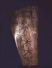 Bone amulet, inscribed by a Batak shaman with a spirit figure, pentacles, writing and other designs from their magic books
