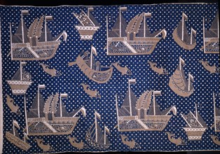 A batik with a design of Portuguese in dug out canoes, steamships and sea creatures