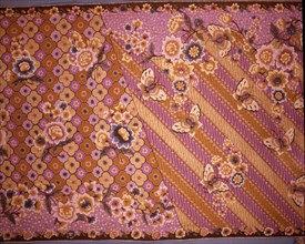A batik sarong with a design of butterflies and flowers over a simplified version of the scrolled background motif known as parang